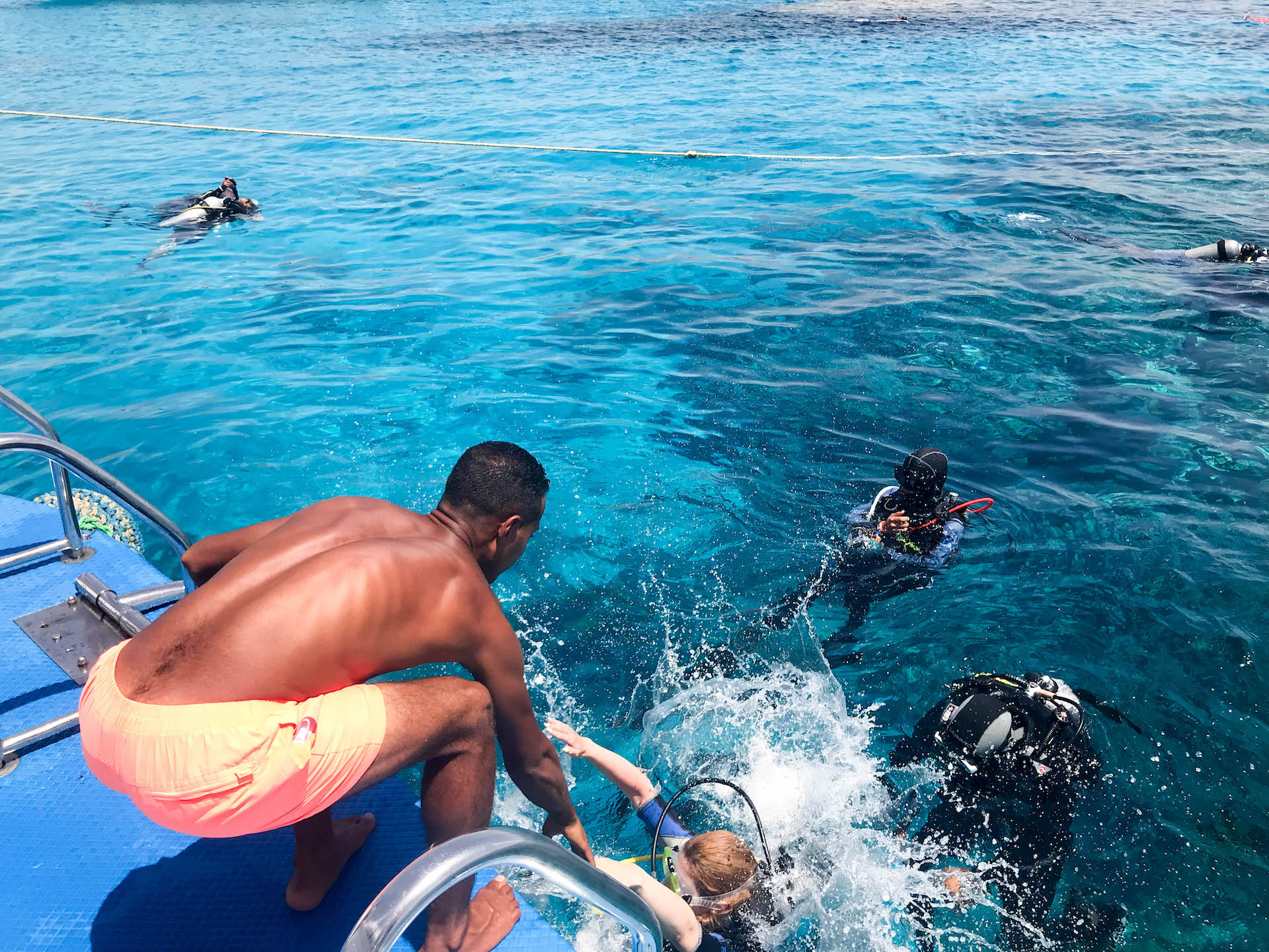 helping a spearfisherman get back onto the boat
